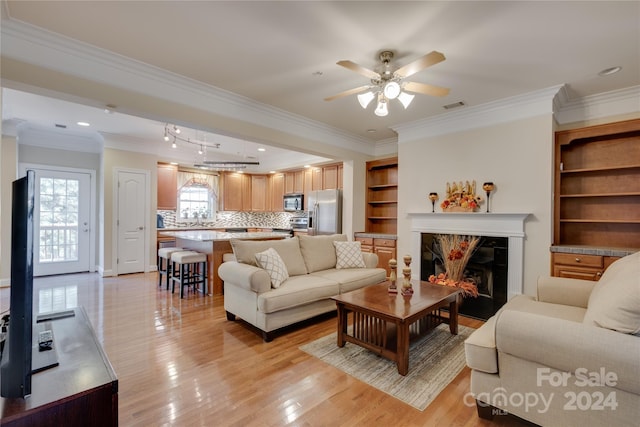 4335 Laurel Hill Ln, Charlotte, NC 28217 - living room with ceiling fan, light hardwood / wood-style flooring, and ornamental molding