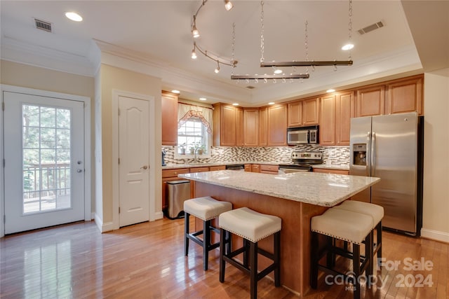 4335 Laurel Hill Ln, Charlotte, NC 28217 - kitchen featuring appliances with stainless steel finishes, light hardwood / wood-style floors, and a kitchen island