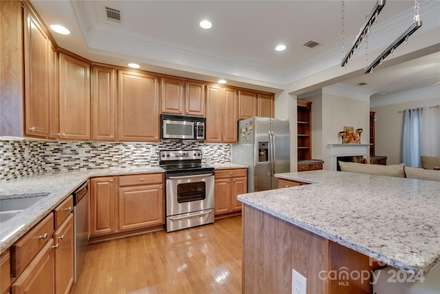 4335 Laurel Hill Ln, Charlotte, NC 28217 - kitchen with light stone countertops, ornamental molding, stainless steel appliances, and light hardwood / wood-style floors