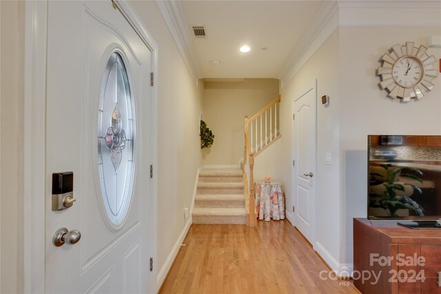 4335 Laurel Hill Ln, Charlotte, NC 28217 - entryway featuring light hardwood / wood-style floors and crown molding