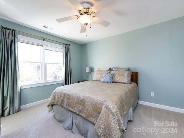 bedroom featuring ceiling fan and light colored carpet