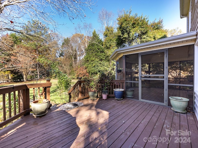 wooden terrace featuring a sunroom