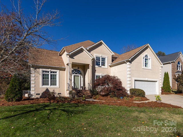 view of front of home featuring a garage and a front lawn