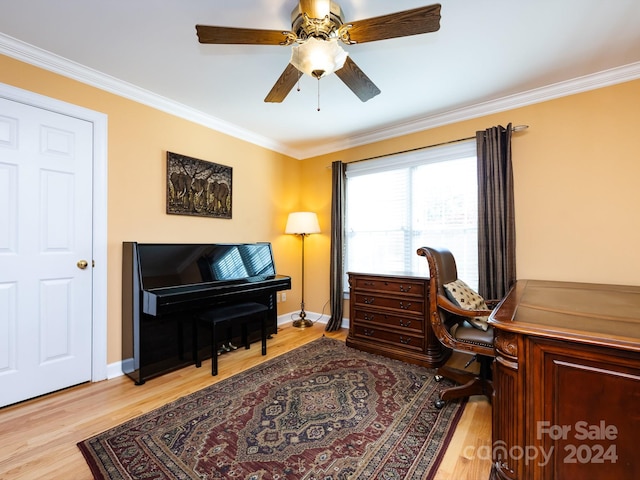 home office with ceiling fan, crown molding, and light wood-type flooring