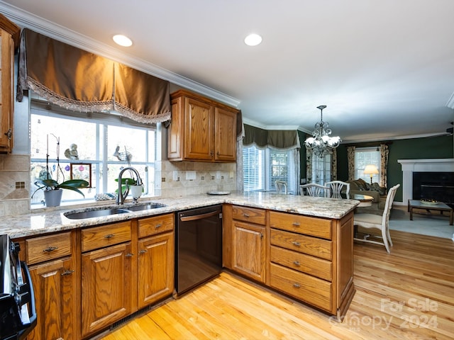 kitchen with black appliances, sink, light wood-type flooring, a healthy amount of sunlight, and kitchen peninsula