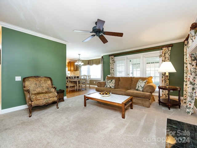 carpeted living room featuring ceiling fan with notable chandelier and crown molding