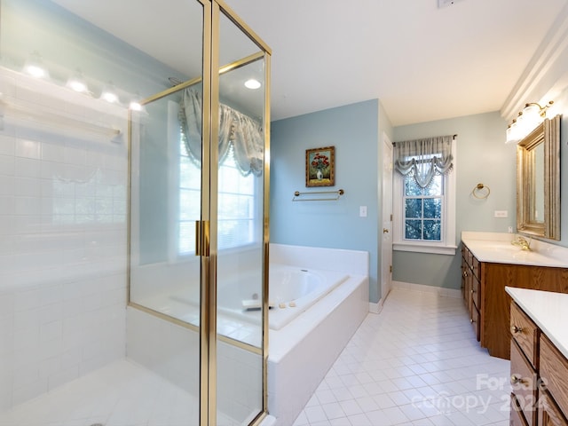 bathroom with tile patterned floors, vanity, and separate shower and tub