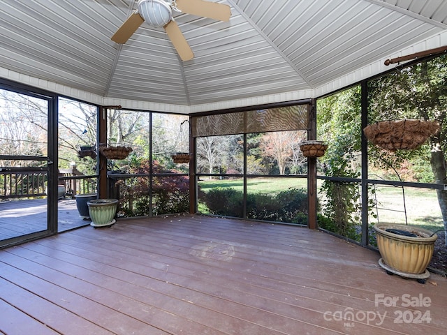 unfurnished sunroom featuring ceiling fan and vaulted ceiling