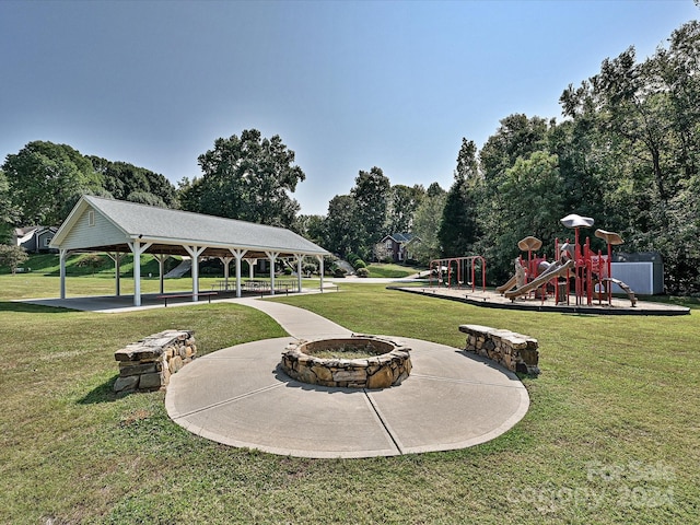 view of yard with a gazebo, a playground, and a fire pit