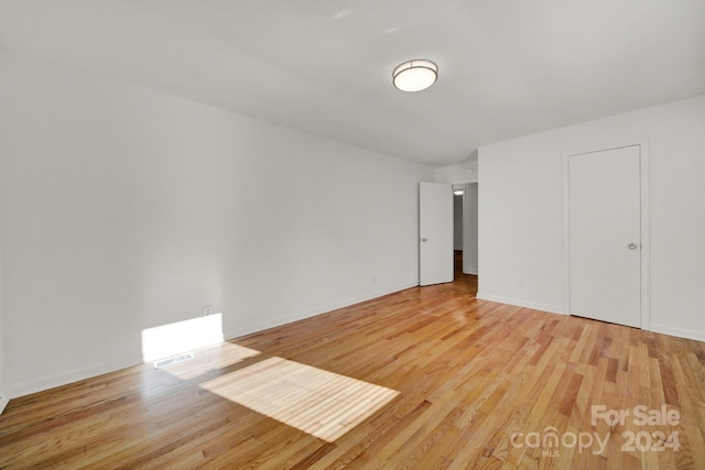 unfurnished bedroom featuring a closet and light hardwood / wood-style flooring