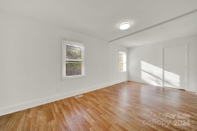 spare room featuring light hardwood / wood-style floors