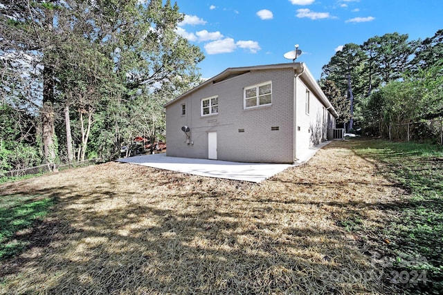 rear view of house featuring a yard and a patio