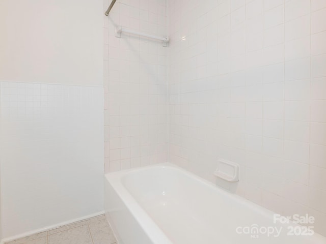 bathroom featuring tile patterned flooring and tile walls