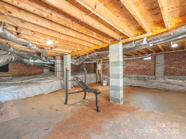 below grade area with brick wall and crawl space