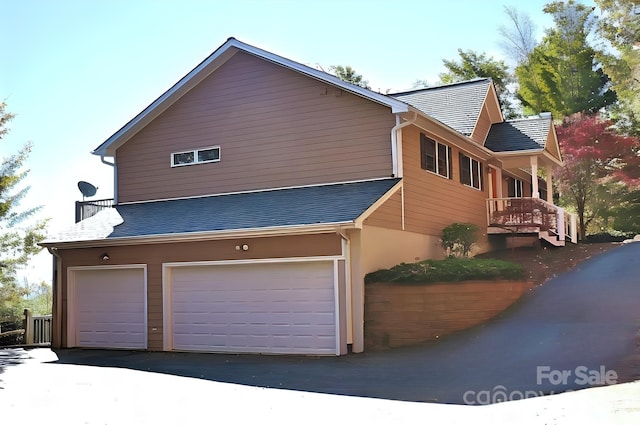 view of side of home with a garage