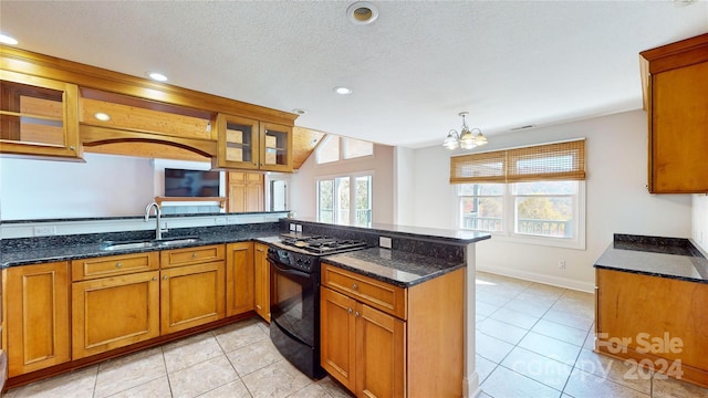 kitchen featuring plenty of natural light, kitchen peninsula, and black range with gas cooktop