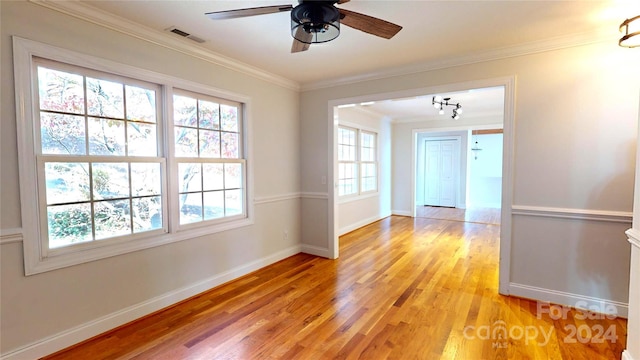 empty room featuring light hardwood / wood-style flooring, ceiling fan, and ornamental molding