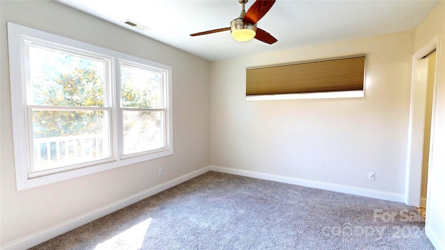 carpeted spare room with ceiling fan