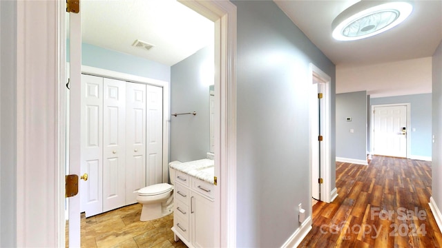 bathroom featuring hardwood / wood-style floors, vanity, and toilet