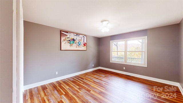 unfurnished room featuring hardwood / wood-style floors