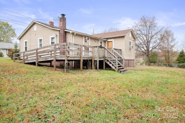 back of property with a deck and a yard