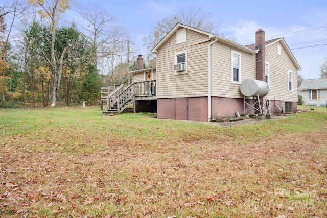 back of house with a yard, central AC, and cooling unit