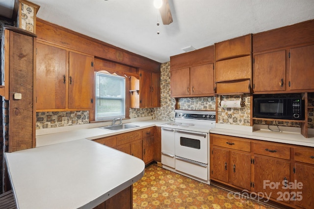 kitchen featuring sink, black microwave, ceiling fan, and white electric stove