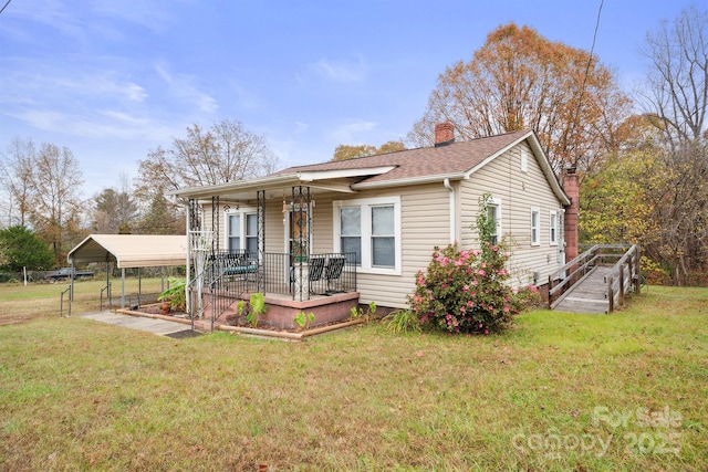 view of front of house with a front yard, covered porch, and a carport