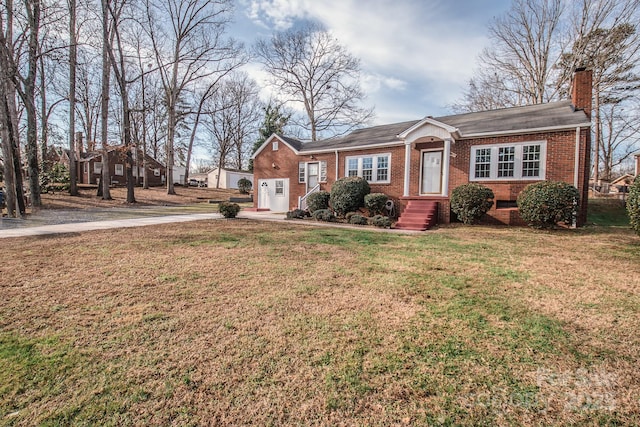 single story home featuring a front lawn and a garage