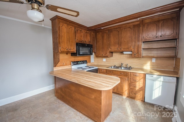 kitchen featuring sink, backsplash, kitchen peninsula, white appliances, and ornamental molding