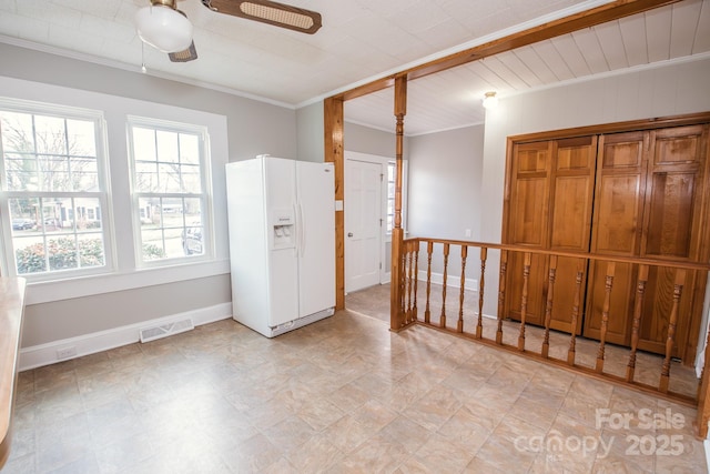 unfurnished room with ceiling fan and ornamental molding