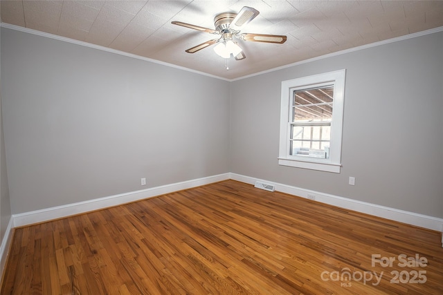 unfurnished room featuring crown molding, hardwood / wood-style floors, and ceiling fan