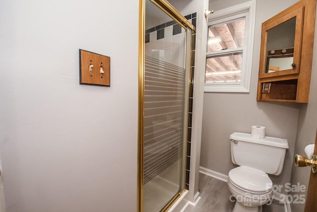 bathroom featuring hardwood / wood-style floors, toilet, and an enclosed shower