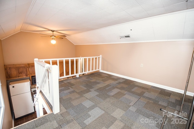 bonus room featuring dark carpet, ceiling fan, and lofted ceiling