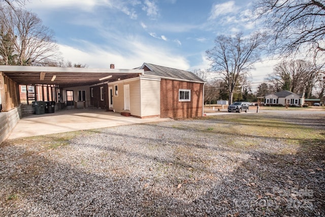 view of side of property with a carport