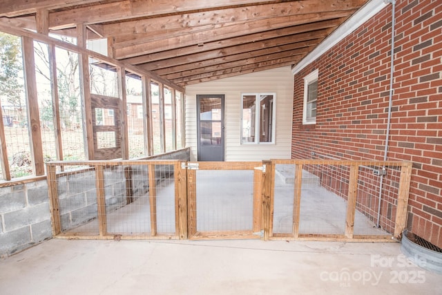 unfurnished sunroom with plenty of natural light and lofted ceiling