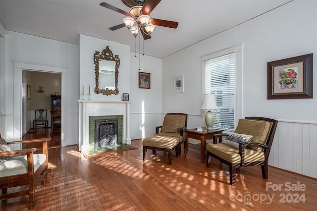 sitting room with ceiling fan and hardwood / wood-style floors