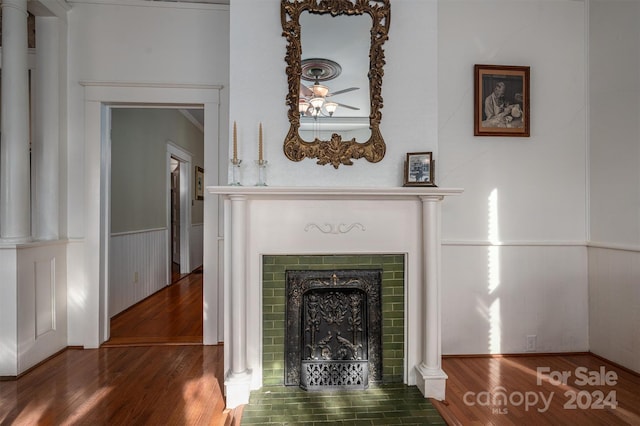 room details featuring a fireplace, hardwood / wood-style floors, and ornamental molding