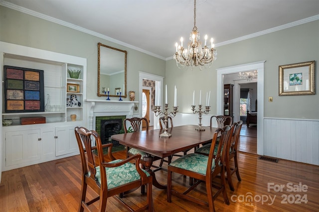 dining room with a chandelier, dark hardwood / wood-style floors, and crown molding