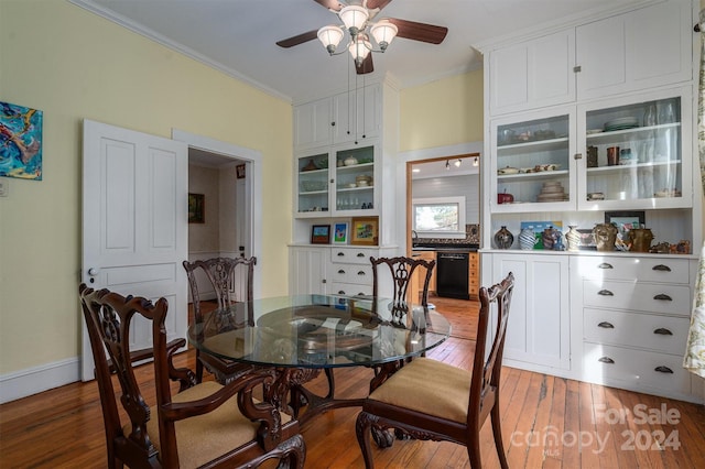 dining room featuring ceiling fan, wood-type flooring, and crown molding