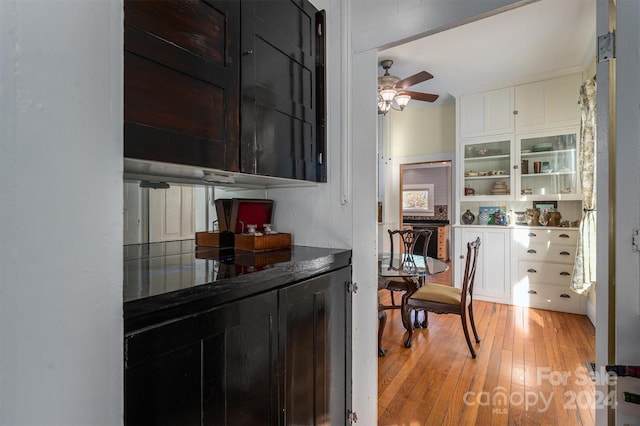 kitchen featuring white cabinets, light hardwood / wood-style floors, and ceiling fan