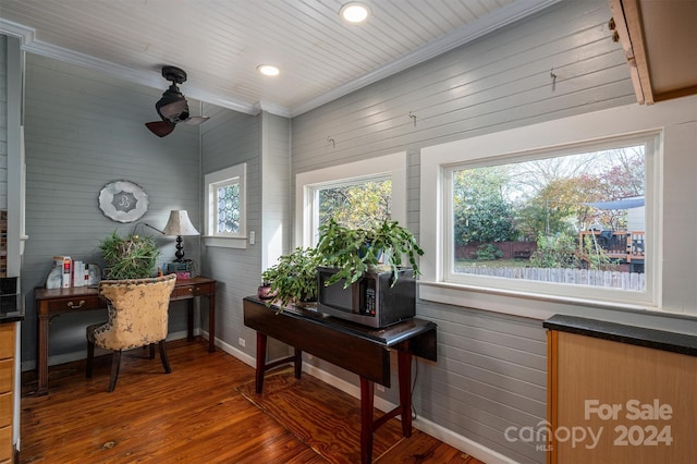 office area featuring wooden walls, dark hardwood / wood-style flooring, and crown molding