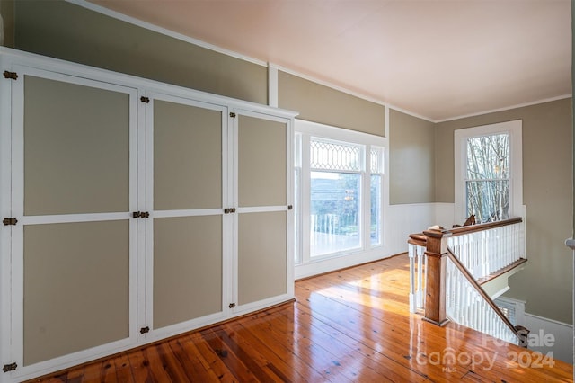 foyer featuring light wood-type flooring and crown molding