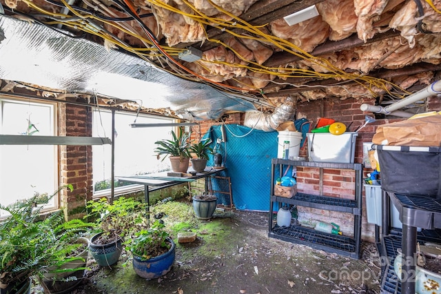 interior space featuring brick wall