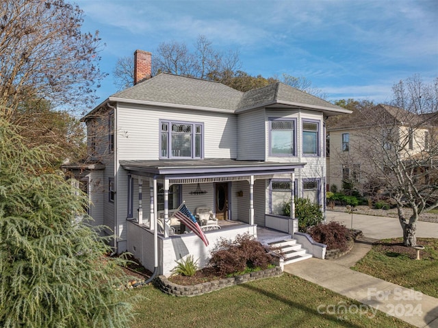 front facade featuring a front yard and a porch