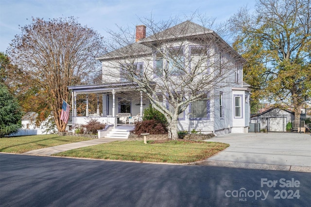 view of front of property with covered porch and a front lawn