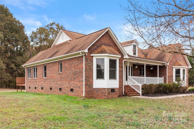 view of property exterior featuring covered porch and a yard