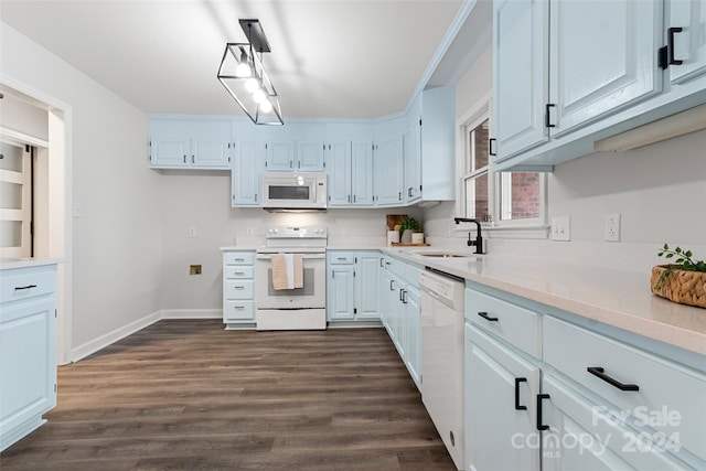 kitchen featuring white appliances, dark hardwood / wood-style floors, white cabinetry, and sink