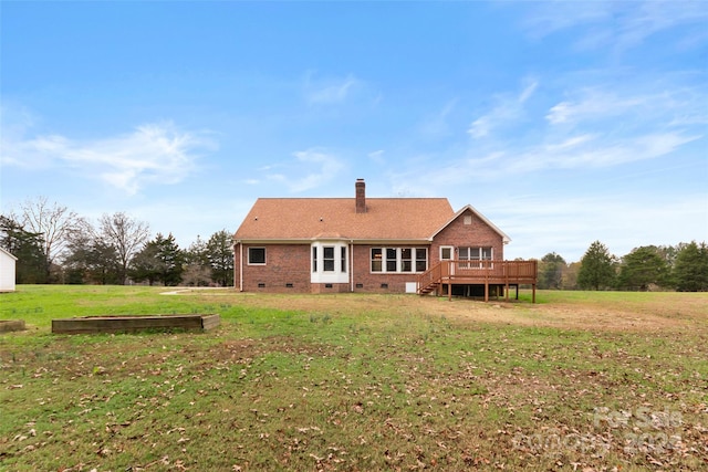 rear view of property with a lawn and a wooden deck