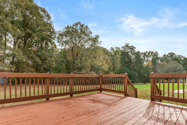 wooden deck with a lawn